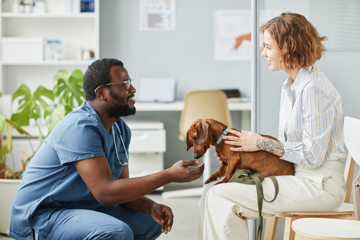 woman at the vet with her dog