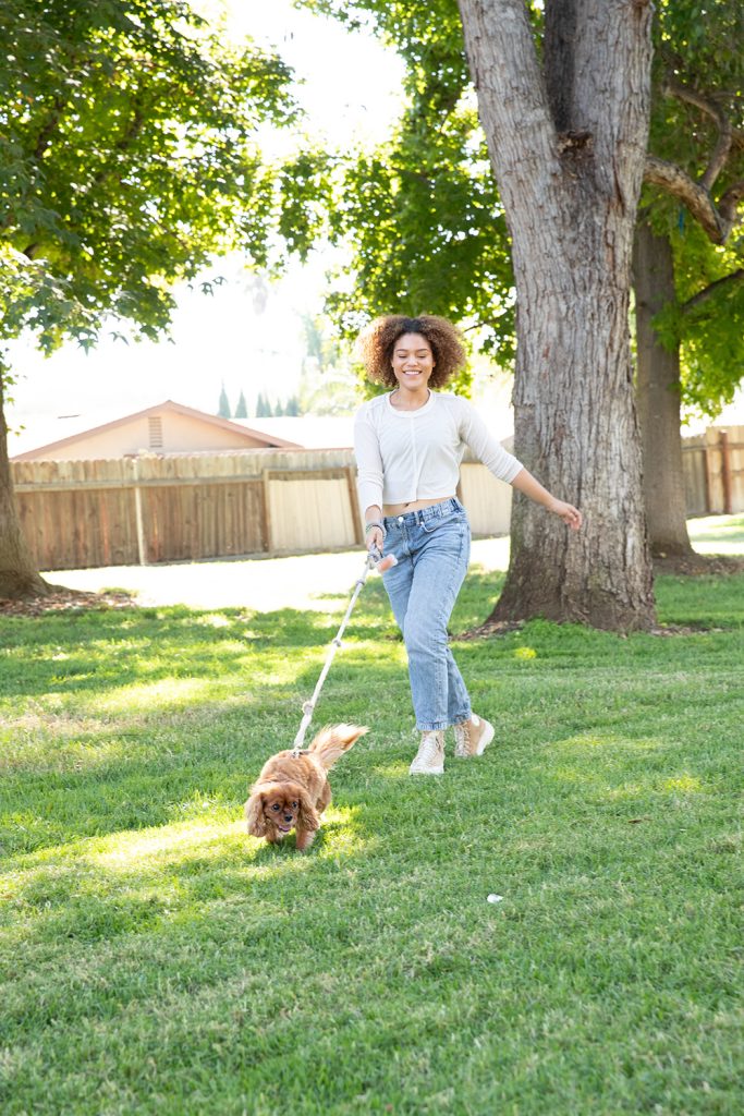 girl walking her dog in a park