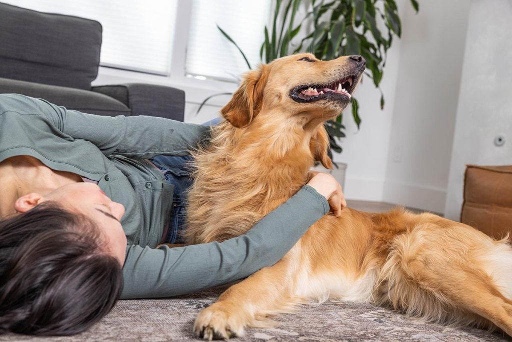 womand and dog cuddling