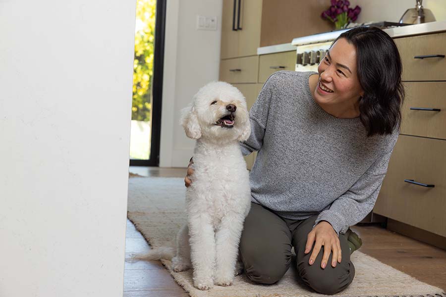 doodle dog smiling next to human